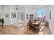 Elegant dining room with wood floors and large windows offering bright, natural light near display cabinet and entrance at 17117 Heartwood Loop, Winter Garden, FL 34787