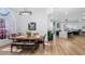 Elegant dining room with hardwood floors, a large arched window, and an open concept layout to the modern kitchen at 17117 Heartwood Loop, Winter Garden, FL 34787