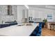 Modern kitchen with white quartz countertops, blue cabinets, stainless steel appliances, and a stylish backsplash at 17117 Heartwood Loop, Winter Garden, FL 34787