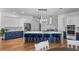 Beautiful kitchen with a large island, stainless steel appliances, blue cabinets, and a stylish backsplash and breakfast bar at 17117 Heartwood Loop, Winter Garden, FL 34787