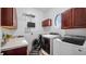 Well-equipped laundry room with modern appliances, storage and pet washing station at 17117 Heartwood Loop, Winter Garden, FL 34787