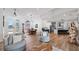 Bright and open living area with hardwood floors, a grand window, and seamless connection to kitchen and dining at 17117 Heartwood Loop, Winter Garden, FL 34787