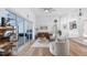 Open-concept living area featuring modern seating, hardwood floors, large sliders to the outside, and stylish decor at 17117 Heartwood Loop, Winter Garden, FL 34787