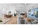 Spacious open-concept living room with hardwood floors, modern decor, and seamless flow into the kitchen and dining areas at 17117 Heartwood Loop, Winter Garden, FL 34787