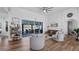 Bright living room with wood floors, modern furniture, and large sliding glass doors to the outdoor living space at 17117 Heartwood Loop, Winter Garden, FL 34787