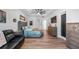 Spacious bedroom with hardwood floors, ceiling fan, sitting area and TV at 17117 Heartwood Loop, Winter Garden, FL 34787
