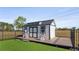A storage shed with white siding, a black roof, and a charming deck at 17117 Heartwood Loop, Winter Garden, FL 34787