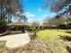 Spacious backyard featuring a screened-in patio and a large stone patio perfect for outdoor gatherings and relaxation at 1738 Athens Ct, Lakeland, FL 33803