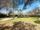 Spacious backyard with a patio area, lush lawn, and mature trees, ideal for outdoor entertaining and relaxation at 1738 Athens Ct, Lakeland, FL 33803