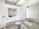 Bright bathroom featuring granite countertops, a tub, and ample natural light at 1738 Athens Ct, Lakeland, FL 33803