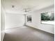 Neutral bedroom with carpet floors, ceiling fan, and a large window at 1738 Athens Ct, Lakeland, FL 33803