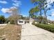 Charming single-story home with a large front yard and a long driveway leading to an attached garage at 1738 Athens Ct, Lakeland, FL 33803