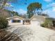 Charming single-story home with a large front yard and a long driveway leading to an attached garage at 1738 Athens Ct, Lakeland, FL 33803