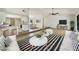 Open-concept living room featuring hardwood floors, ceiling fan, and breakfast bar connecting to the modern kitchen at 1738 Athens Ct, Lakeland, FL 33803