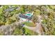 Stunning aerial view of estate featuring a pool, circular driveway, and manicured lawn at 1943 Wingfield Dr, Longwood, FL 32779