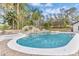 Beautiful backyard pool with rock waterfall, surrounded by lush tropical landscaping at 1943 Wingfield Dr, Longwood, FL 32779