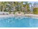 Inviting swimming pool with a rock waterfall surrounded by lush tropical landscaping at 1943 Wingfield Dr, Longwood, FL 32779