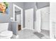 Bathroom with a shower and toilet through doorways, white tile, and marble floors at 1943 Wingfield Dr, Longwood, FL 32779