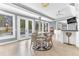 Bright dining area boasts natural light with French doors, decorative chandelier, adjacent wet bar, and seating for four at 1943 Wingfield Dr, Longwood, FL 32779