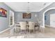 Formal dining room with a crystal chandelier, neutral colors, and bright natural lighting at 1943 Wingfield Dr, Longwood, FL 32779
