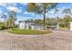 Long driveway leads to beautiful white home with a three-car garage and white gated entrance at 1943 Wingfield Dr, Longwood, FL 32779