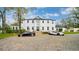 Stunning white two-story home with a circular driveway and two luxury sports cars at 1943 Wingfield Dr, Longwood, FL 32779