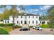 Beautiful two-story white home with two luxury cars parked out front in circular driveway at 1943 Wingfield Dr, Longwood, FL 32779