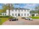 An exterior shot of a two-story white home with brick driveway and manicured landscaping at 1943 Wingfield Dr, Longwood, FL 32779