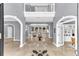 Elegant foyer with marble floors, arched doorways, and views of the pool and backyard at 1943 Wingfield Dr, Longwood, FL 32779