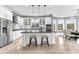 Bright kitchen featuring white cabinetry, black countertops, mosaic backsplash, stainless appliances, and an eating area at 1943 Wingfield Dr, Longwood, FL 32779