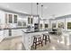 Bright kitchen featuring white cabinetry, black countertops, mosaic backsplash, and an eat-in dining area at 1943 Wingfield Dr, Longwood, FL 32779
