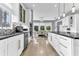 Bright kitchen featuring white cabinetry, black countertops, stainless steel appliances, and an eat-in dining area at 1943 Wingfield Dr, Longwood, FL 32779