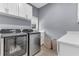 This laundry room has new Samsung appliances, white cabinets, and quartz countertops at 1943 Wingfield Dr, Longwood, FL 32779