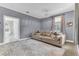 Cozy bedroom features an inviting sofa with decorative pillows, and an attached ensuite bathroom at 1943 Wingfield Dr, Longwood, FL 32779