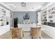 Bright home office featuring custom built-in shelving, a safe, and modern decor at 1943 Wingfield Dr, Longwood, FL 32779