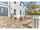 A stone patio featuring an outdoor seating area with trees and landscaping in the background at 1943 Wingfield Dr, Longwood, FL 32779