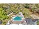 Aerial view of the outdoor pool area featuring a spa, lounge chairs, and manicured landscaping at 1943 Wingfield Dr, Longwood, FL 32779