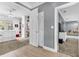 Hallway leads to a large walk-in closet with custom shelving and an adjacent bedroom at 1943 Wingfield Dr, Longwood, FL 32779