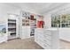 Bright walk-in closet with custom shelving, center island, and access to an en-suite bathroom at 1943 Wingfield Dr, Longwood, FL 32779