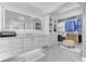Bright walk-in closet with custom shelving, an ottoman, and a large, illuminated vanity mirror at 1943 Wingfield Dr, Longwood, FL 32779