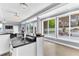 Kitchen wet bar with a black granite countertop, beverage refrigerator, and pool views at 1943 Wingfield Dr, Longwood, FL 32779