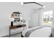 Bedroom featuring a modern vanity with a round mirror and a view of the outdoors at 1977 Branched Oak Rd, St Cloud, FL 34771