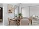 Stylish dining area with seating for four, shiplap accent wall and sliding glass doors to the outdoor space at 1977 Branched Oak Rd, St Cloud, FL 34771