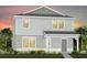 Charming two-story home with light green siding and a welcoming front porch at 1977 Branched Oak Rd, St Cloud, FL 34771