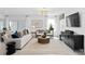 Open-concept living room with plenty of natural light, a decorative chandelier, and a stylish accent wall at 1977 Branched Oak Rd, St Cloud, FL 34771