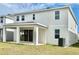 Spacious backyard with a covered patio, perfect for outdoor entertaining and enjoying the beautiful green space at 1988 Iorio Dr, St Cloud, FL 34771