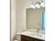 Modern bathroom with a white vanity, a large mirror and vanity lighting at 1988 Iorio Dr, St Cloud, FL 34771