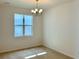Bright dining room featuring a modern chandelier and large window offering ample natural light at 1988 Iorio Dr, St Cloud, FL 34771