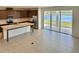 Spacious kitchen and open floor plan with stainless steel appliances and a large island overlooking a beautiful lake view at 1988 Iorio Dr, St Cloud, FL 34771
