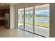 Open-concept kitchen adjacent to a covered lanai, offering a view of the lake with stainless steel appliances at 1988 Iorio Dr, St Cloud, FL 34771